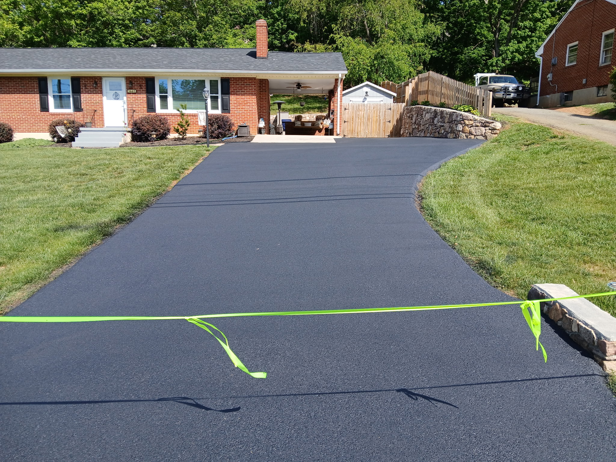 Freshly sealed driveway by Hot Rocks Paving & Sealing LLC